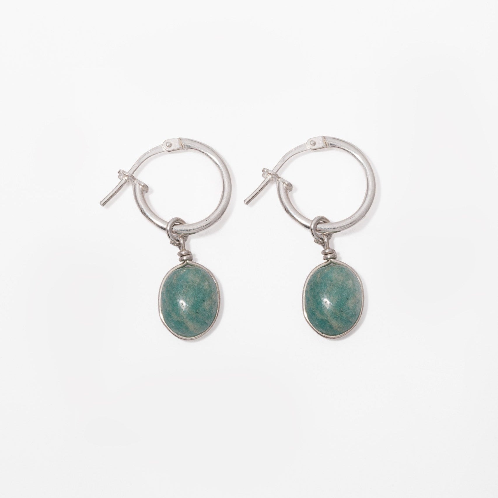 A pair of silver hoop earrings with Amazonite stone oval green gemstone drops, shown on a plain white background.