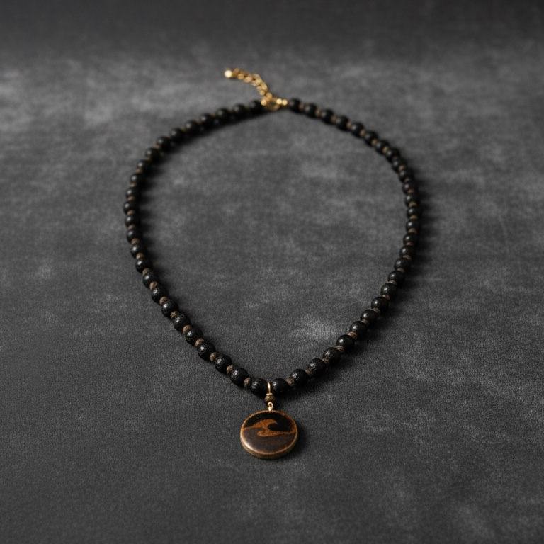 Black beaded necklace with a wooden wave pendant on a dark gray background
