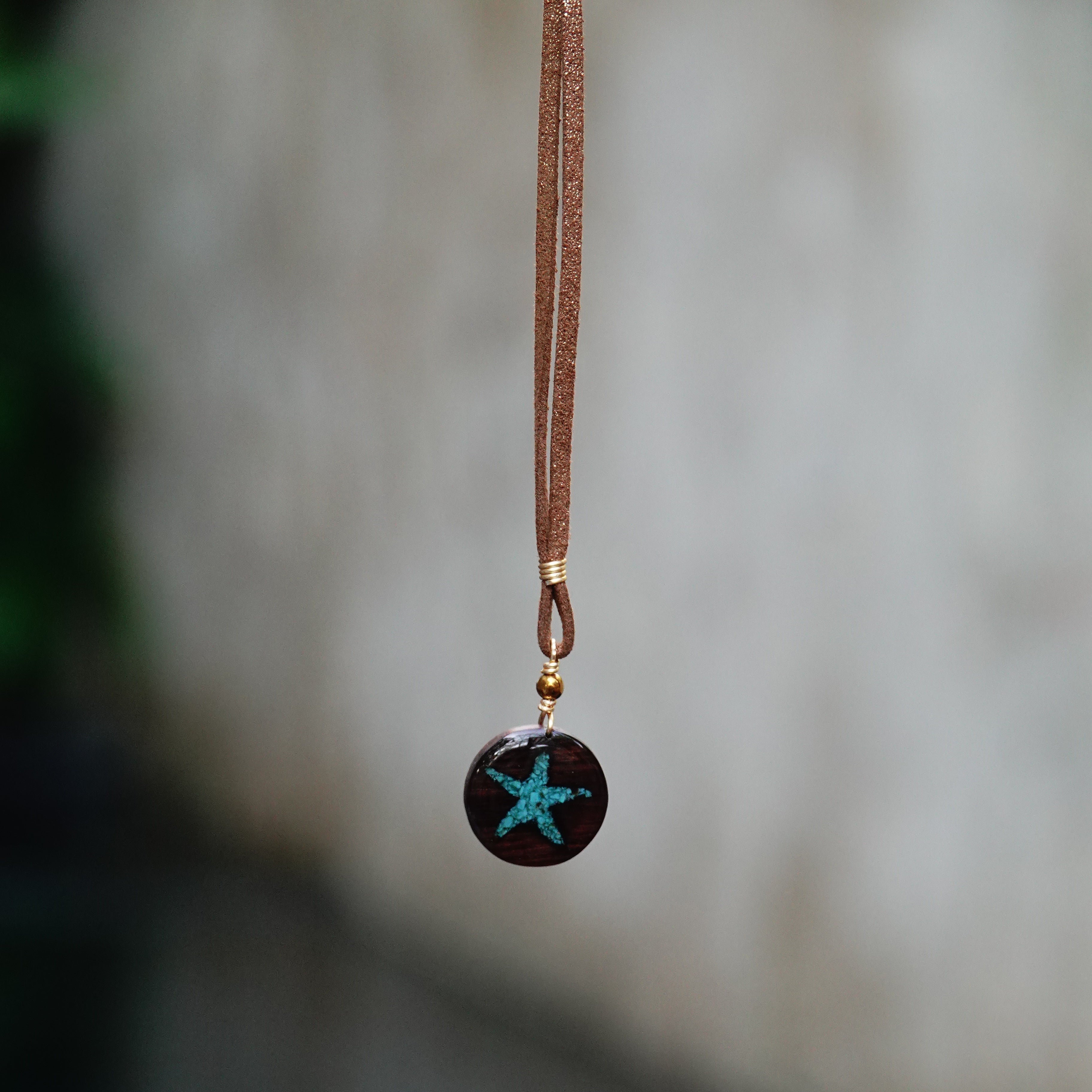 Necklace with a starfish pendant on a blurred background