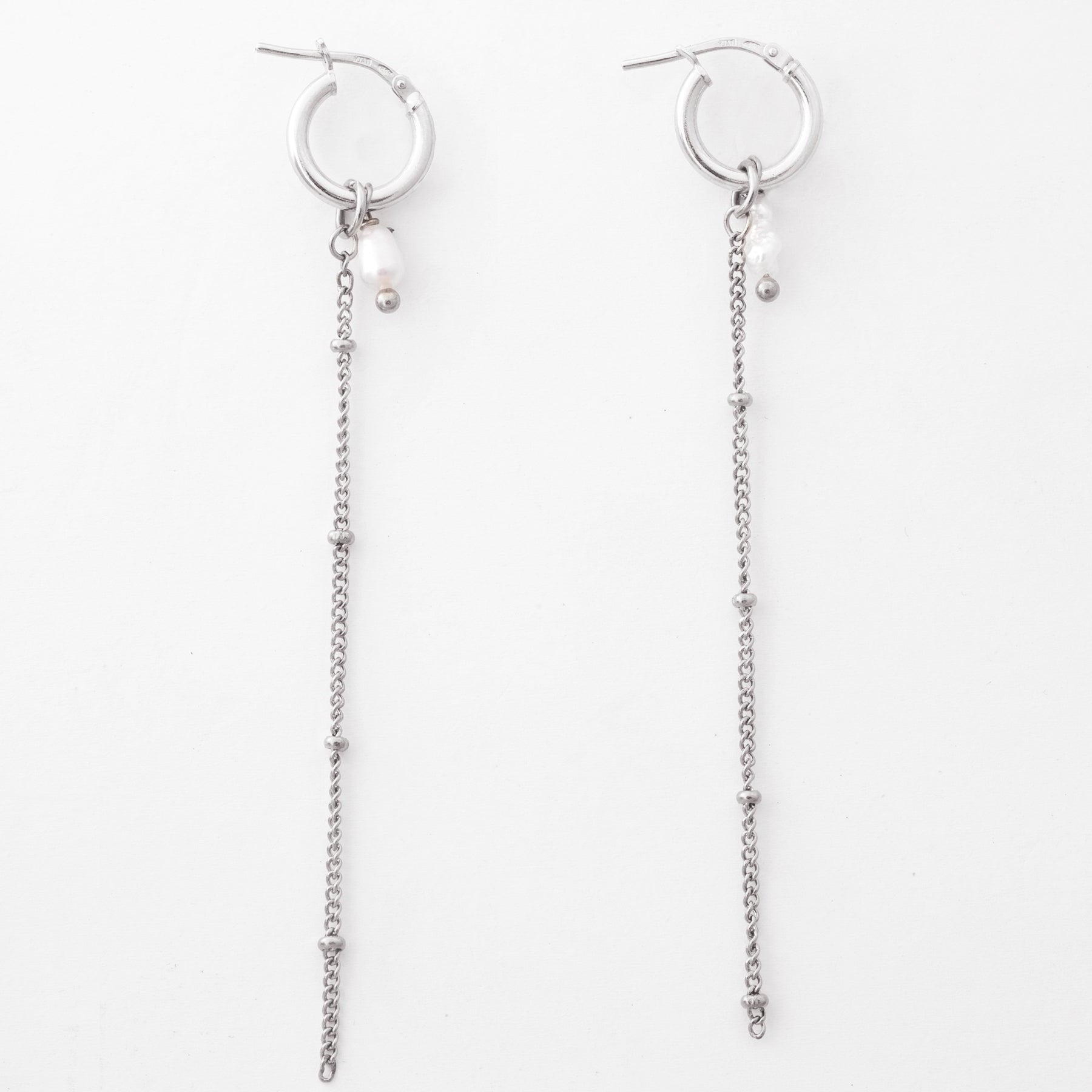 Silver hoop earrings with chain extensions on a white background